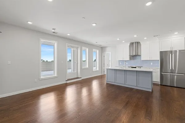 a large kitchen with a large window appliances and cabinets