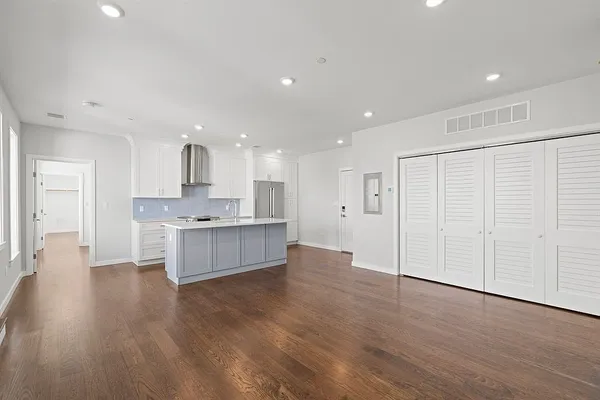 a large kitchen with a lot of counter top space and stainless steel appliances