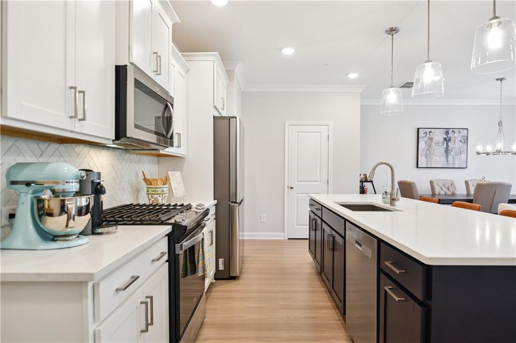 765 Trevett Way Marietta, GA 30066 - Photo 3 of 44 a kitchen with stainless steel appliances granite countertop a sink a stove and a wooden floors