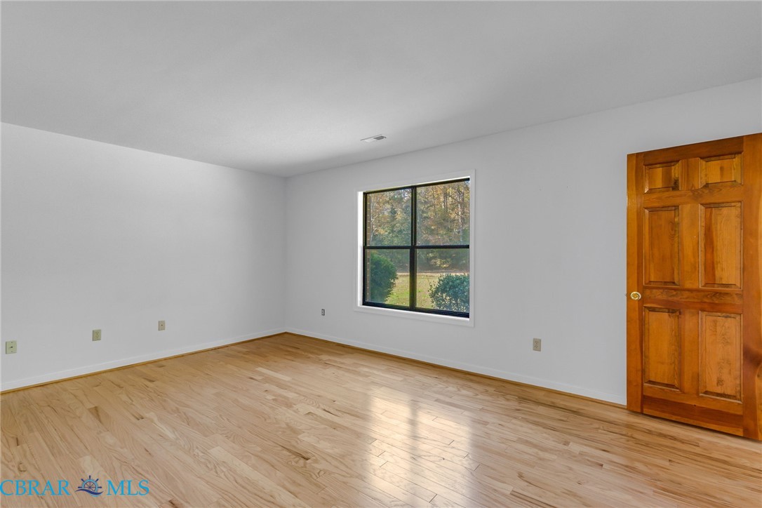 278 Regent Road Hartfield, VA 23071 - Photo 22 of 49 Empty room with light wood-style flooring and baseboards