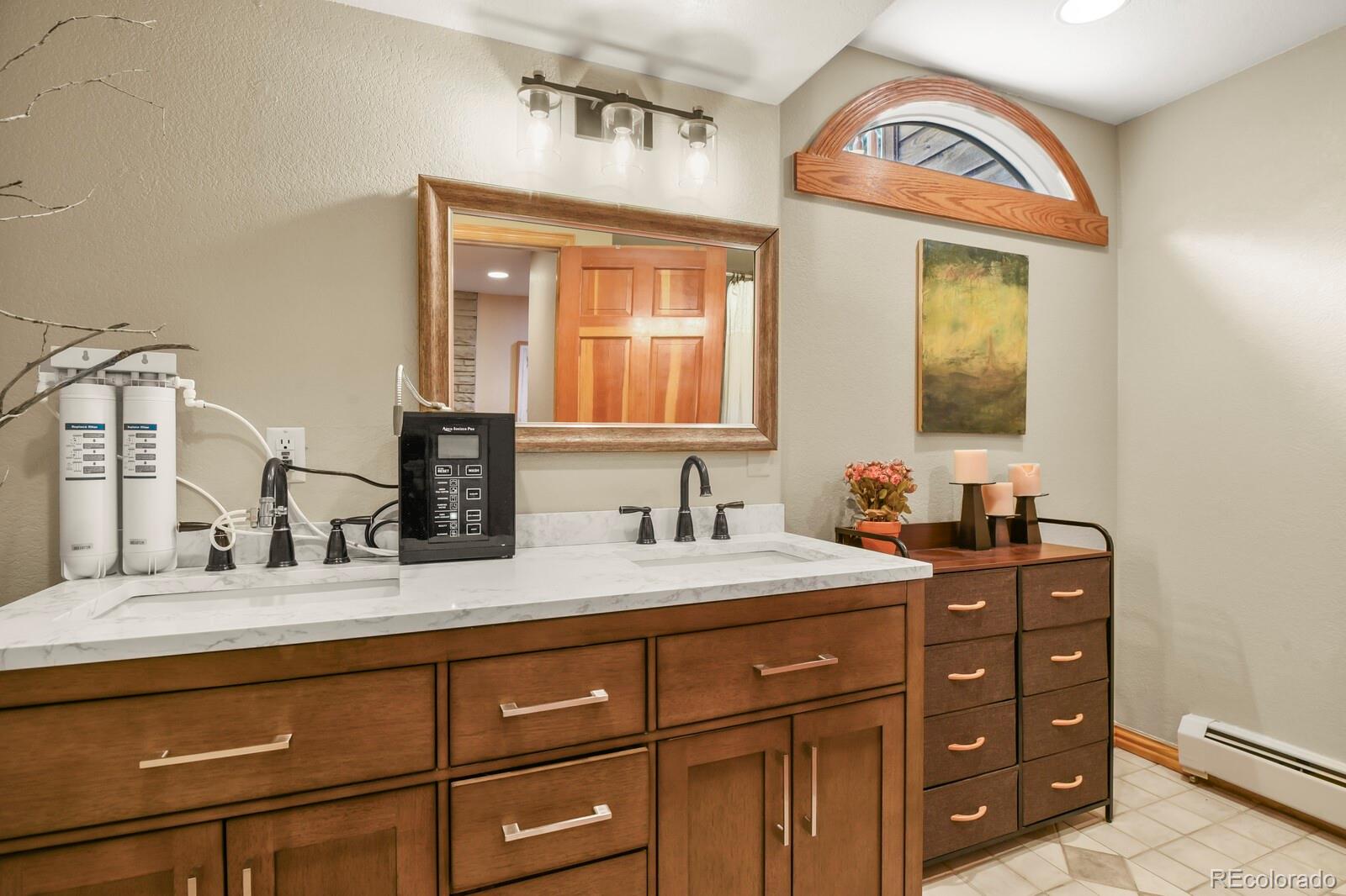 417 Witter Gulch Road Evergreen, CO 80439 - Photo 37 of 50 a bathroom with a sink and a mirror