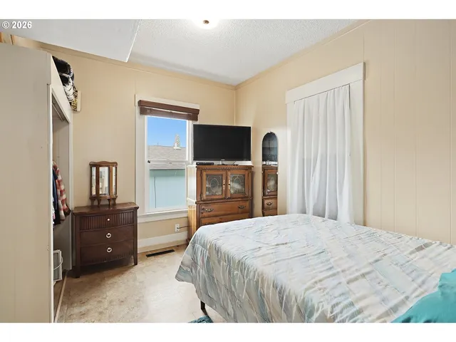 a bedroom with a bed and a television