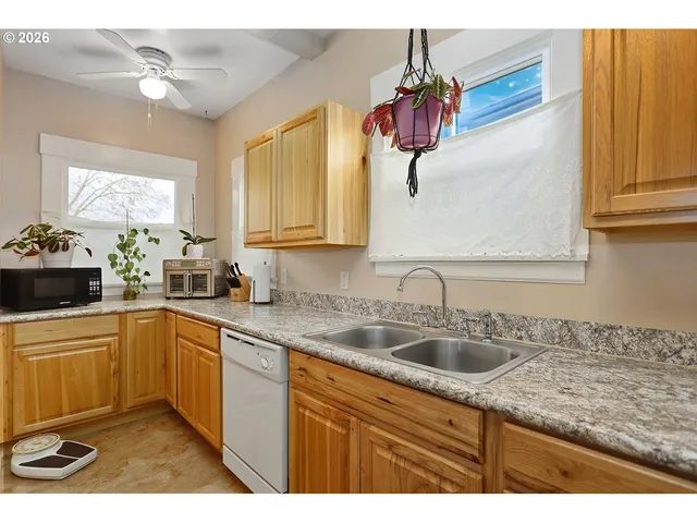 a kitchen with a sink cabinets and window