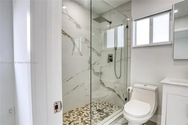 a bathroom with a toilet and a shower