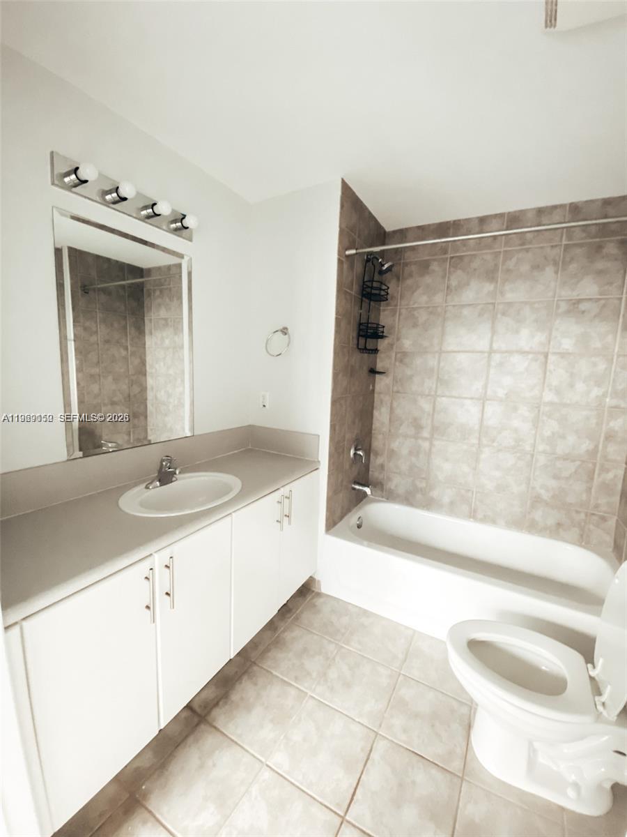 455 Northeast 25th Street, Unit 809 Miami, FL 33137 - Photo 12 of 18 a bathroom with a granite countertop sink mirror and bathtub