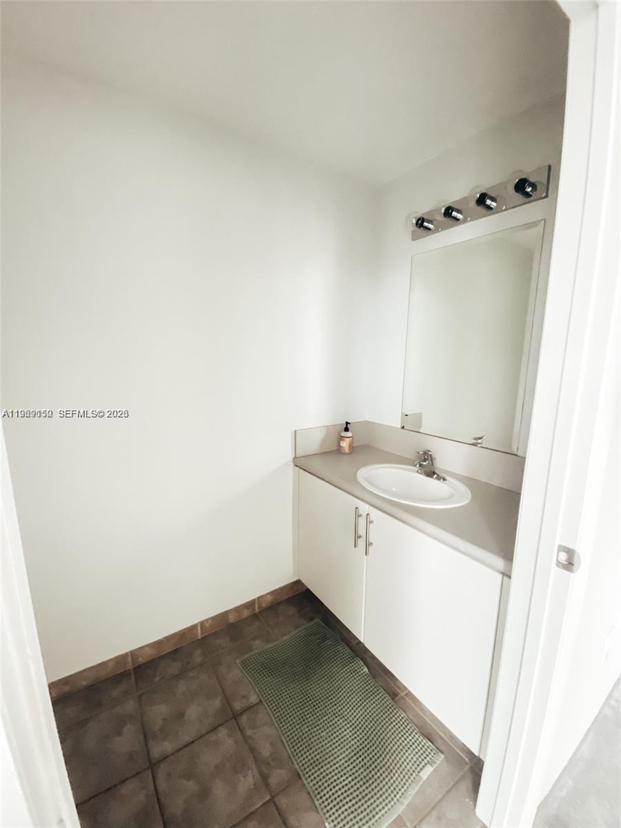 455 Northeast 25th Street, Unit 809 Miami, FL 33137 - Photo 13 of 18 a bathroom with a sink and a mirror