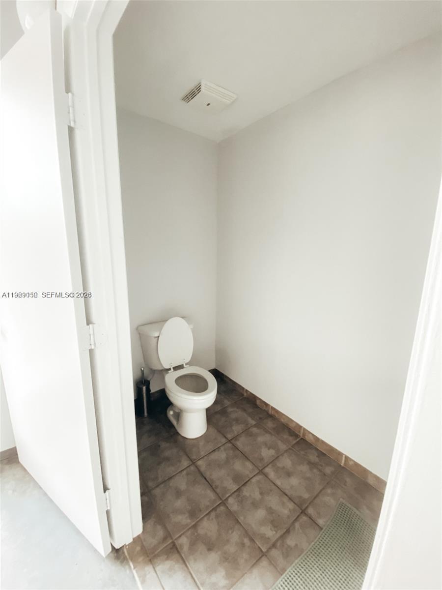 455 Northeast 25th Street, Unit 809 Miami, FL 33137 - Photo 14 of 18 a white toilet sitting next to a shower