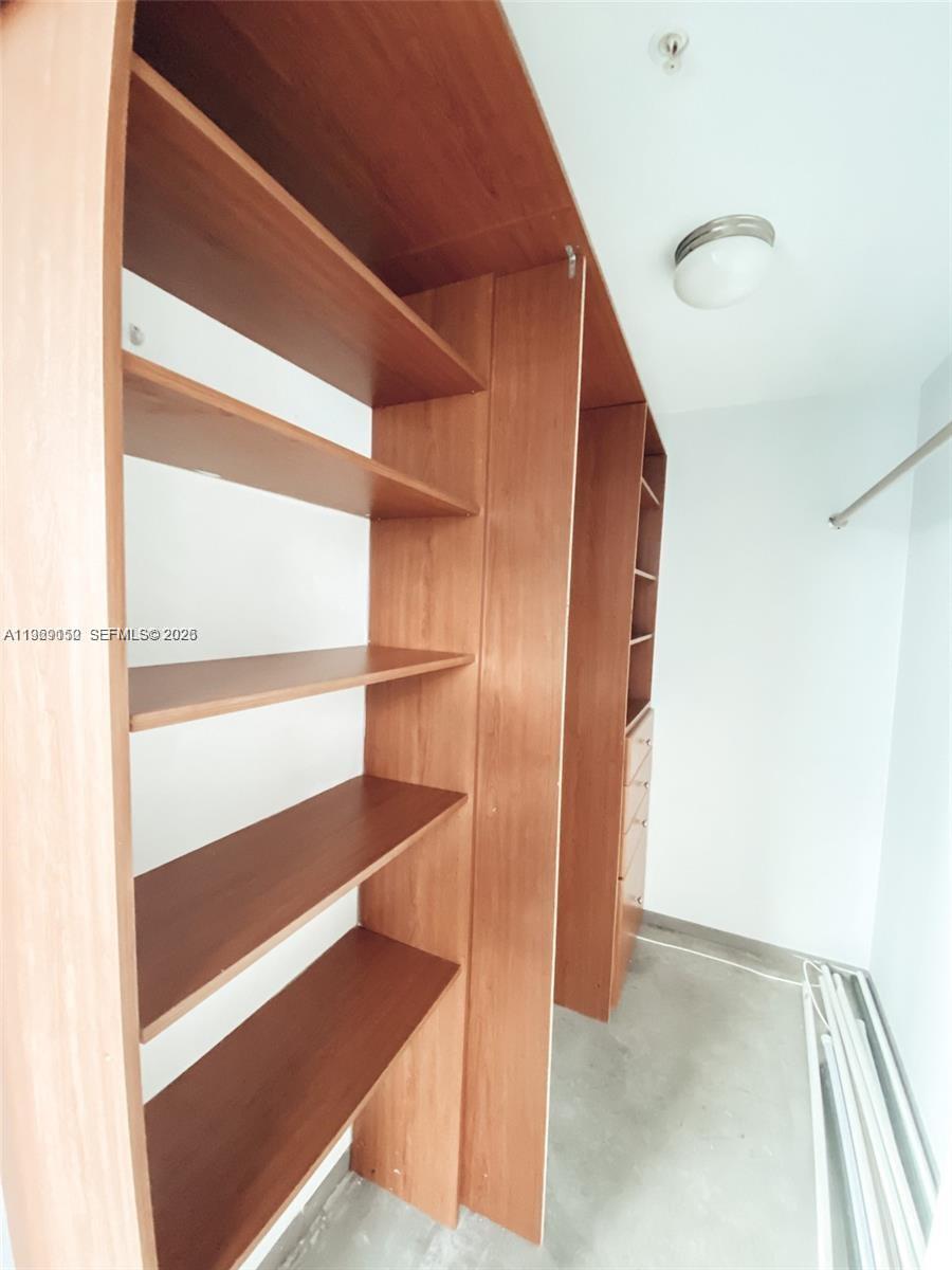 455 Northeast 25th Street, Unit 809 Miami, FL 33137 - Photo 16 of 18 a view of walk in closet with empty racks