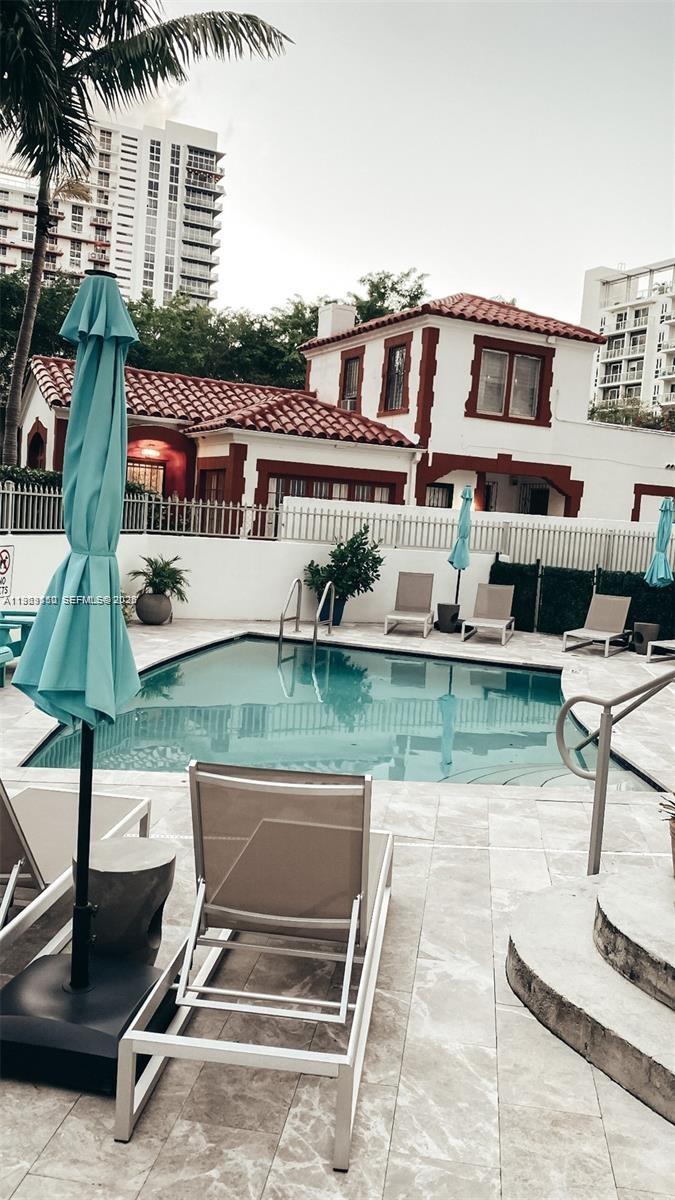 455 Northeast 25th Street, Unit 809 Miami, FL 33137 - Photo 2 of 18 a front view of house with yard and seating area