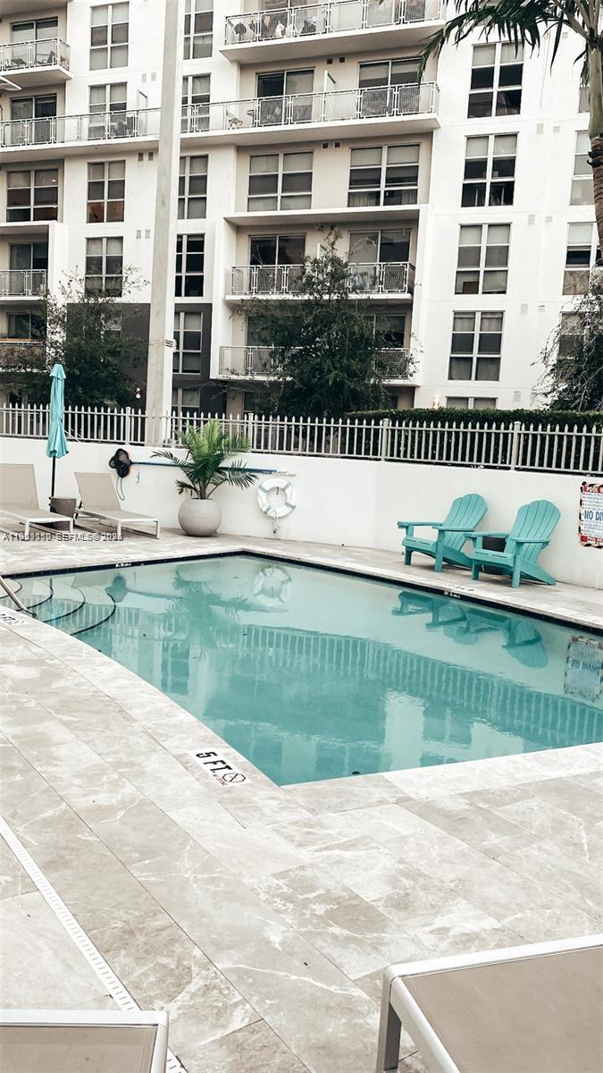 455 Northeast 25th Street, Unit 809 Miami, FL 33137 - Photo 3 of 18 a front view of a house with a yard