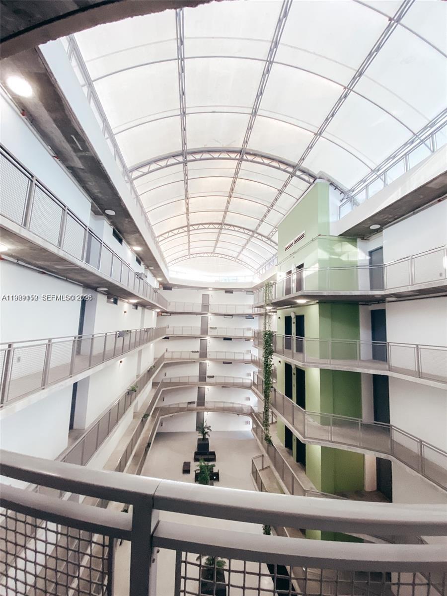 455 Northeast 25th Street, Unit 809 Miami, FL 33137 - Photo 4 of 18 a view of a staircase with wooden floor and a floor to ceiling window