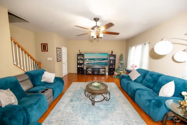 a living room with furniture a rug and a chandelier