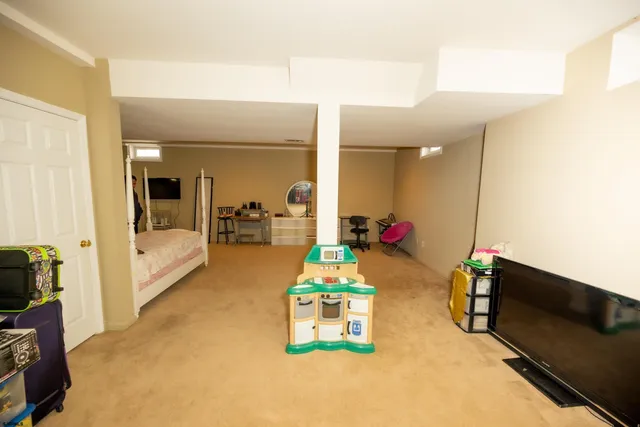 a room with gym equipment and a chandelier