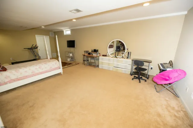 a bedroom with a bed and a large mirror