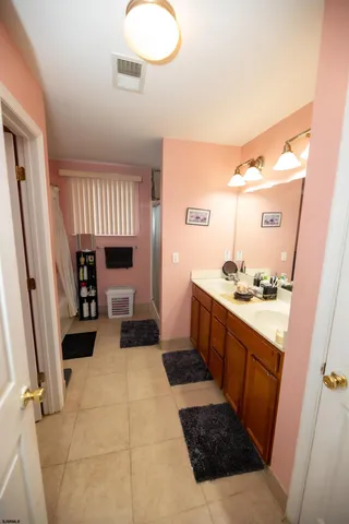 a large bathroom with a sink a toilet and a mirror