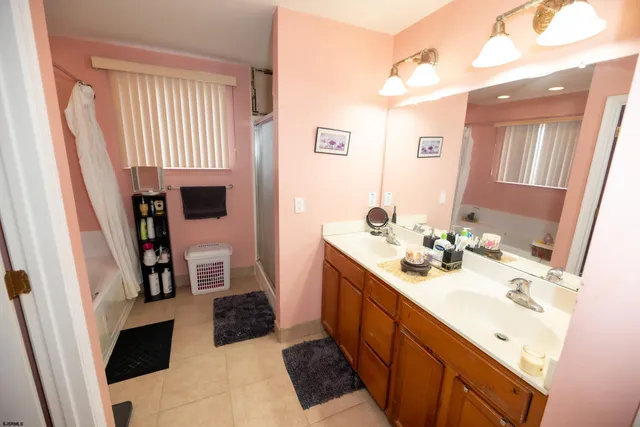 a bathroom with a sink double vanity and a mirror