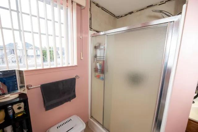 a bathroom with a microwave and a shower