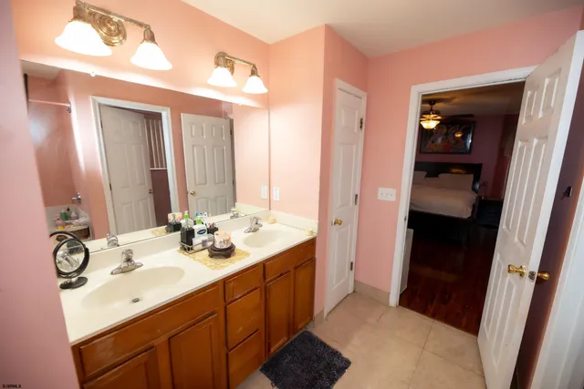 a bathroom with a sink vanity granite and a mirror