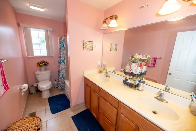 a bathroom with a sink mirror and a toilet