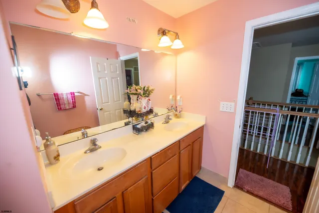 a bathroom with a sink vanity granite and a mirror