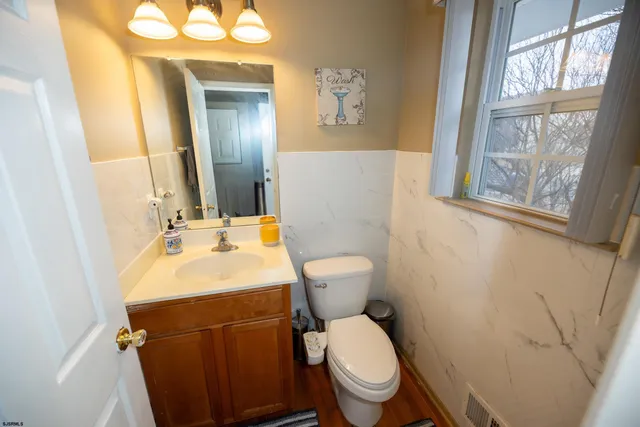 a bathroom with a toilet sink and mirror