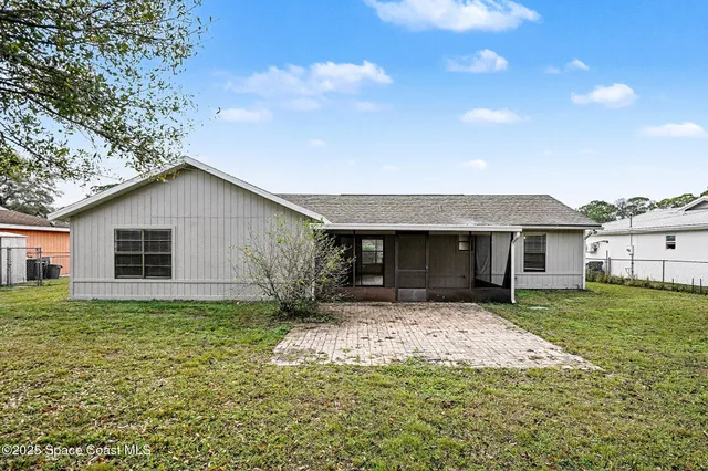a front view of house with yard and trees