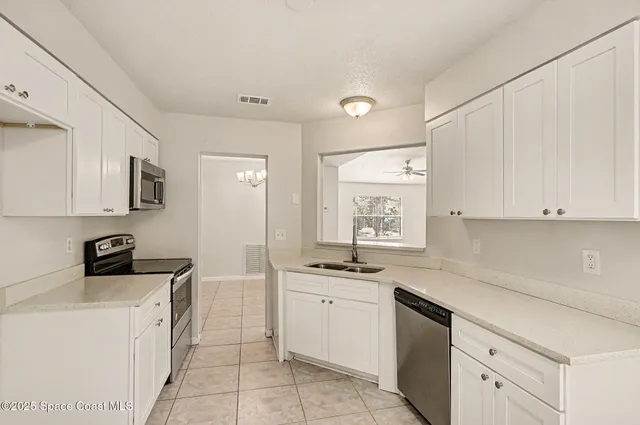 a kitchen with a sink stove and cabinets