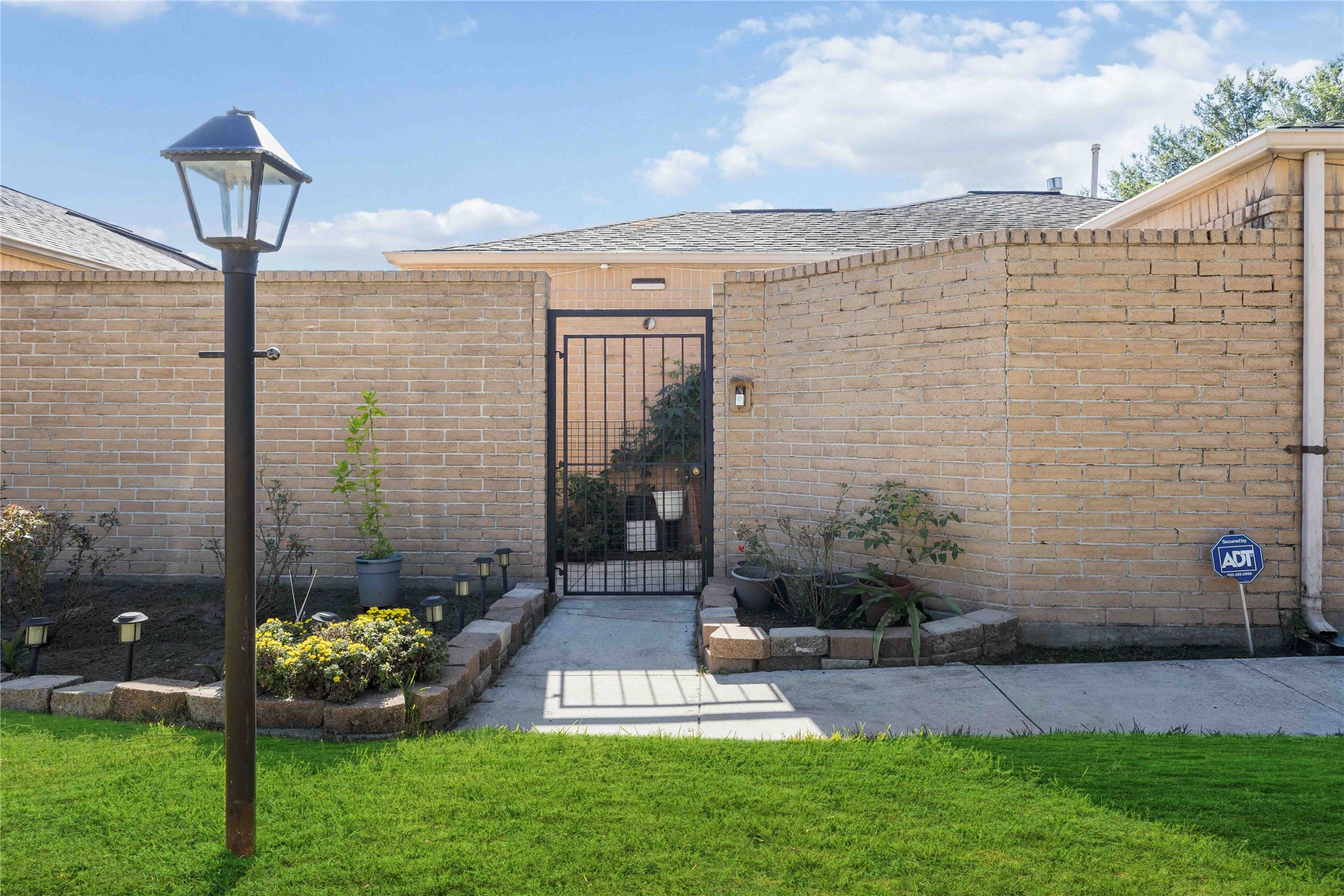a front view of a house with a garden and patio