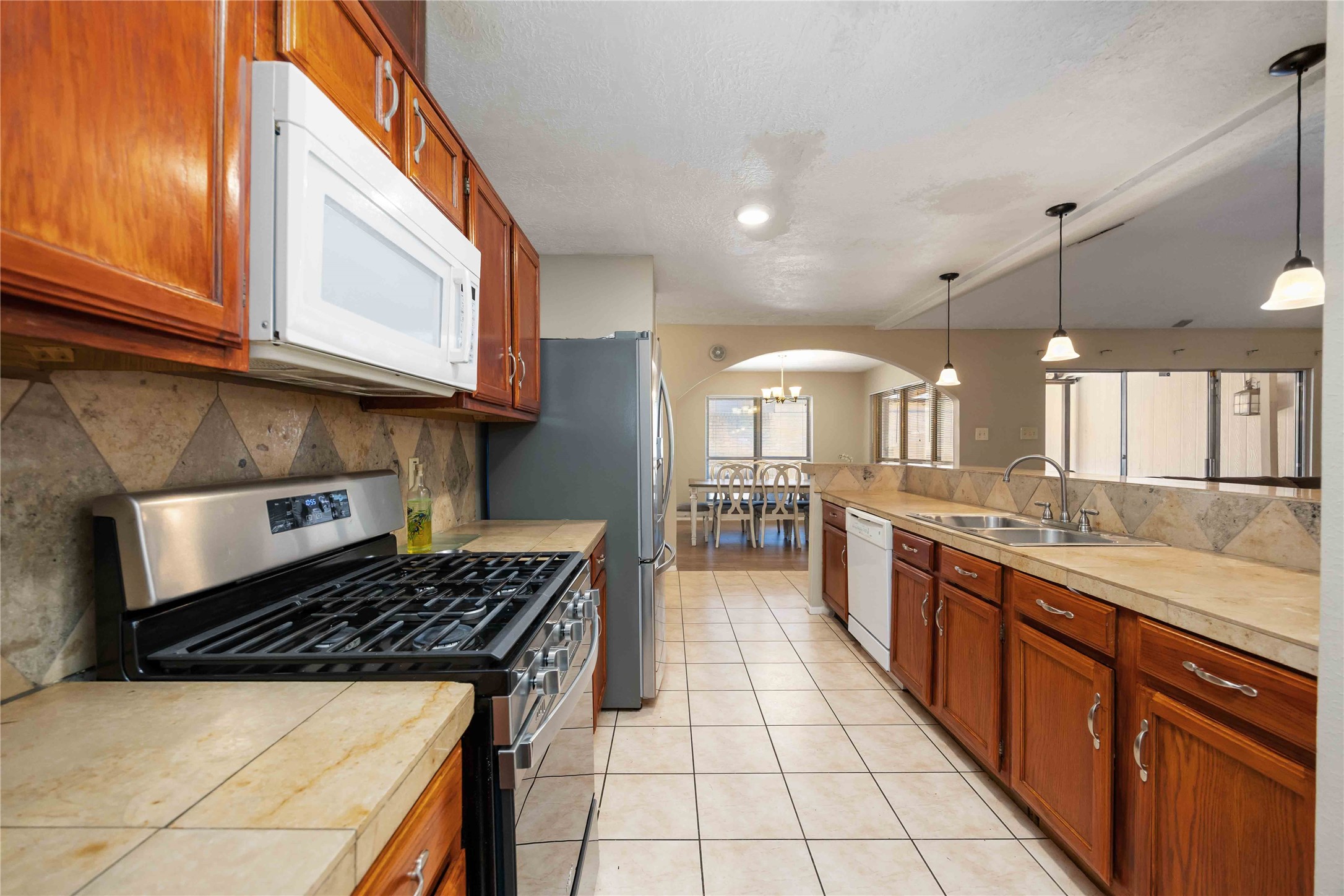 2423 Prides Crossing Road Houston, TX 77067 - Photo 14 of 27 a kitchen with stainless steel appliances granite countertop a stove a sink and a microwave