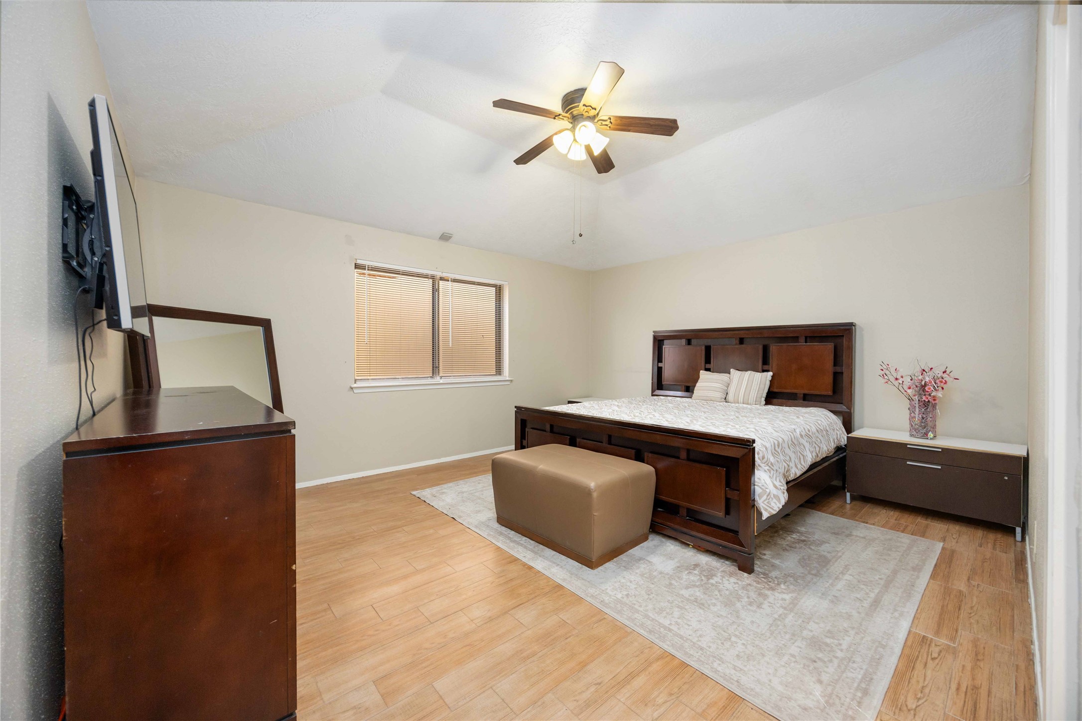 2423 Prides Crossing Road Houston, TX 77067 - Photo 17 of 27 a bedroom with a bed and a chandelier