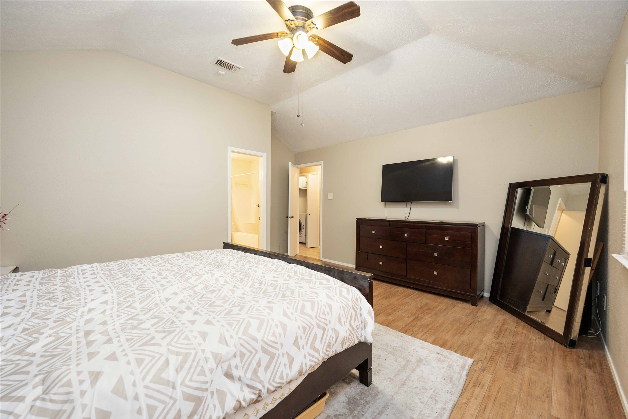 2423 Prides Crossing Road Houston, TX 77067 - Photo 18 of 27 a bedroom with a bed and a flat tv screen on dresser