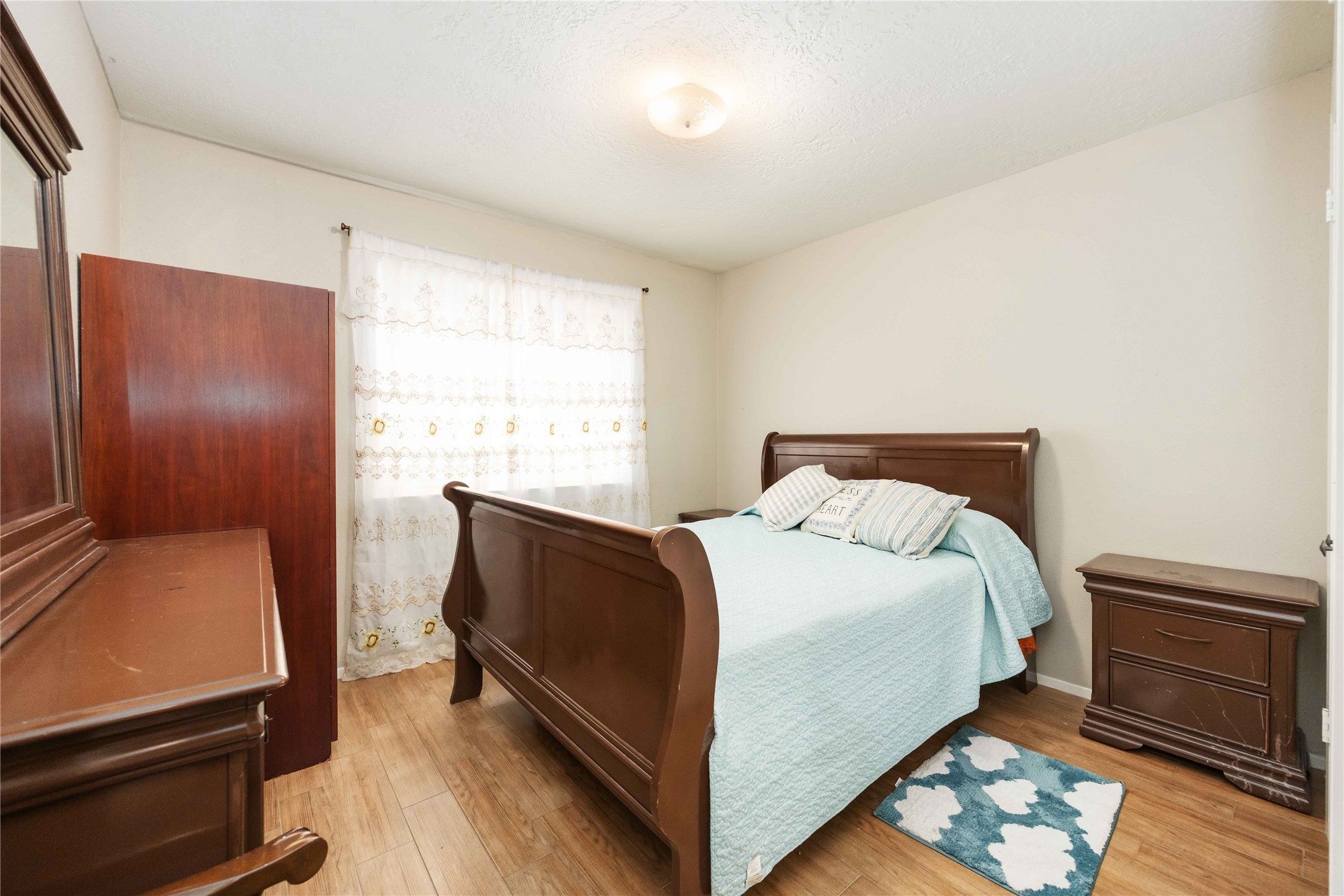 2423 Prides Crossing Road Houston, TX 77067 - Photo 21 of 27 a bed sitting in a bedroom next to a window