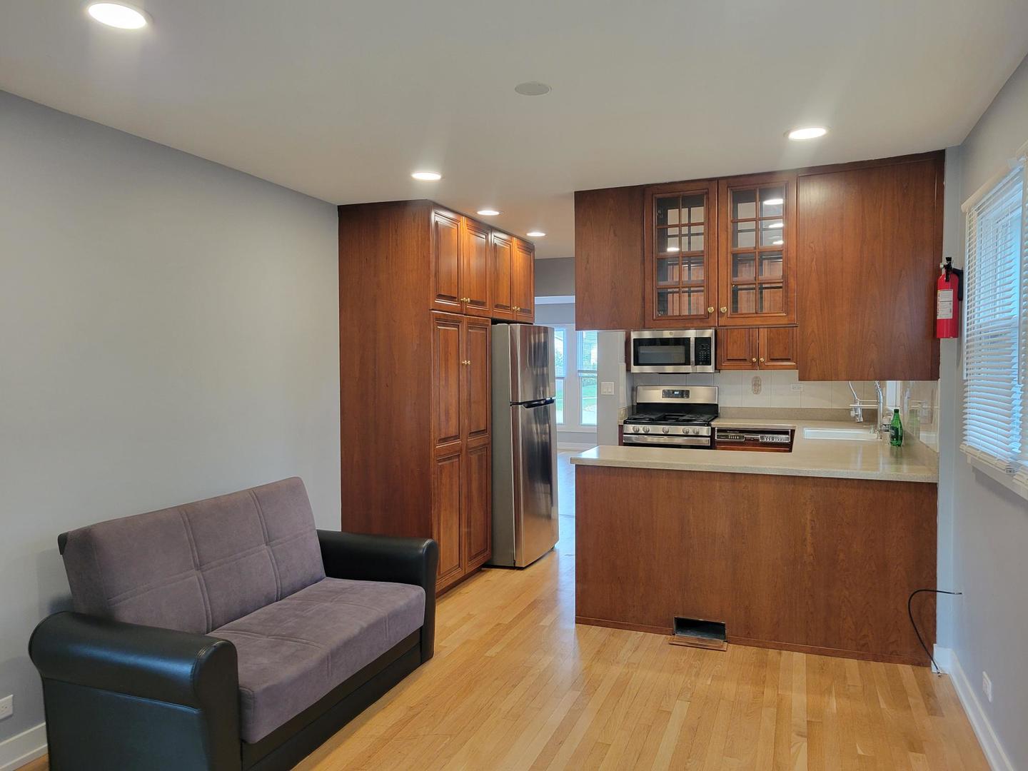 1001 East Callero Circle, Unit 1 Mount Prospect, IL 60056 - Photo 5 of 14 a living room with stainless steel appliances kitchen island granite countertop furniture and a rug