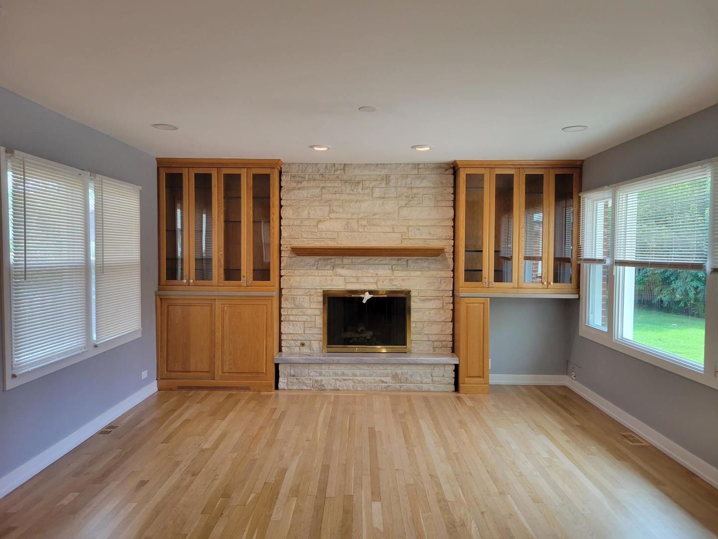 1001 East Callero Circle, Unit 1 Mount Prospect, IL 60056 - Photo 8 of 14 wooden floor fireplace and windows in an empty room