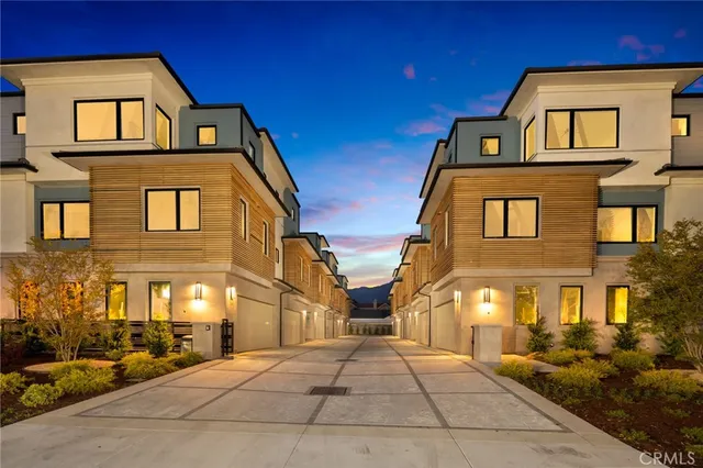 a front view of a residential apartment building with a yard