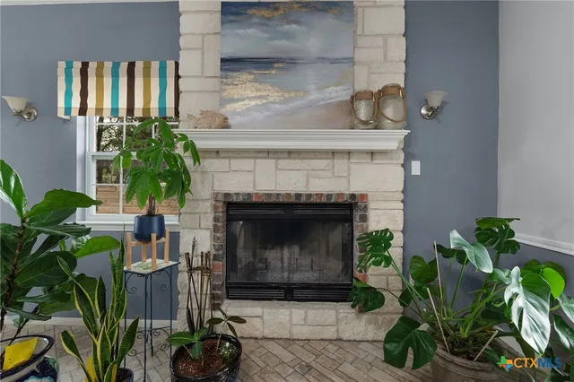 a living room with a potted plant and a fireplace