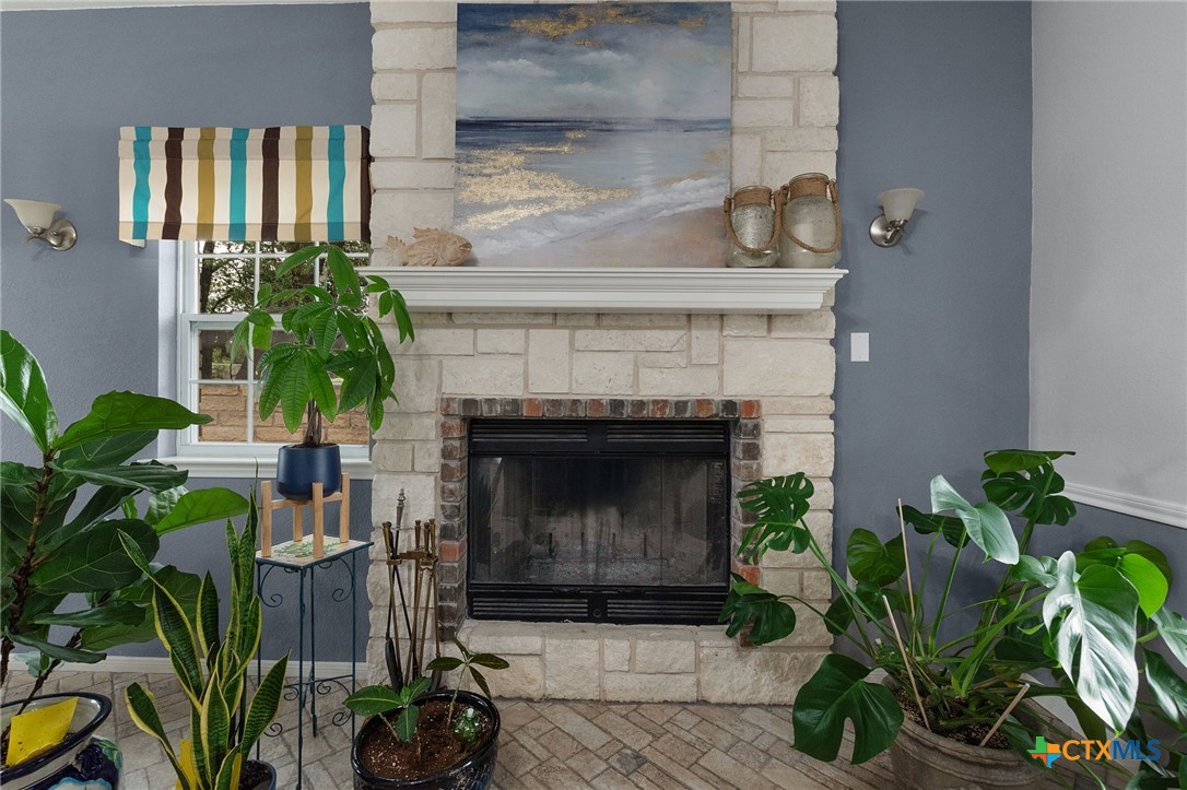 812 Taylor Creek Road Copperas Cove, TX 76522 - Photo 16 of 44 a living room with a potted plant and a fireplace