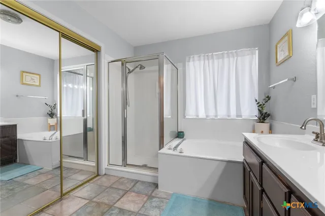 a bathroom with a tub sink and a mirror