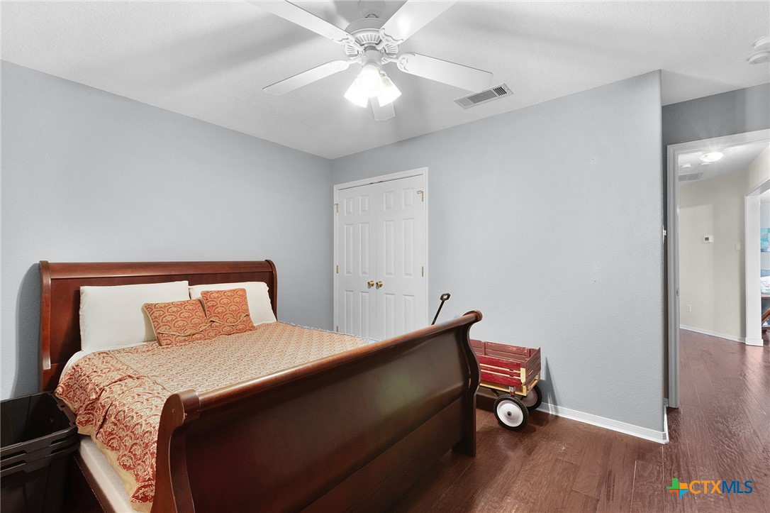 812 Taylor Creek Road Copperas Cove, TX 76522 - Photo 22 of 44 a bedroom with a bed and a chandelier