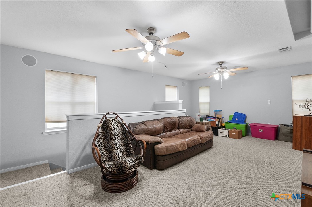 812 Taylor Creek Road Copperas Cove, TX 76522 - Photo 29 of 44 a living room with furniture and a chandelier