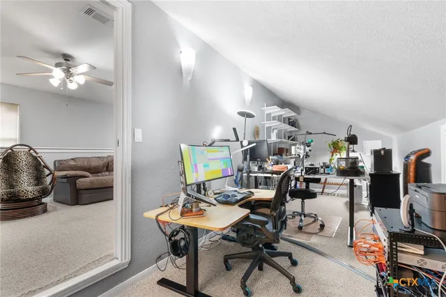 a view of a workspace with furniture and a livingroom