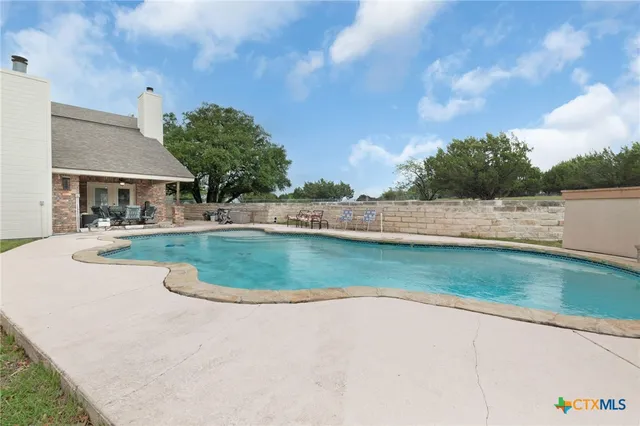 a view of a house with a yard and lake view