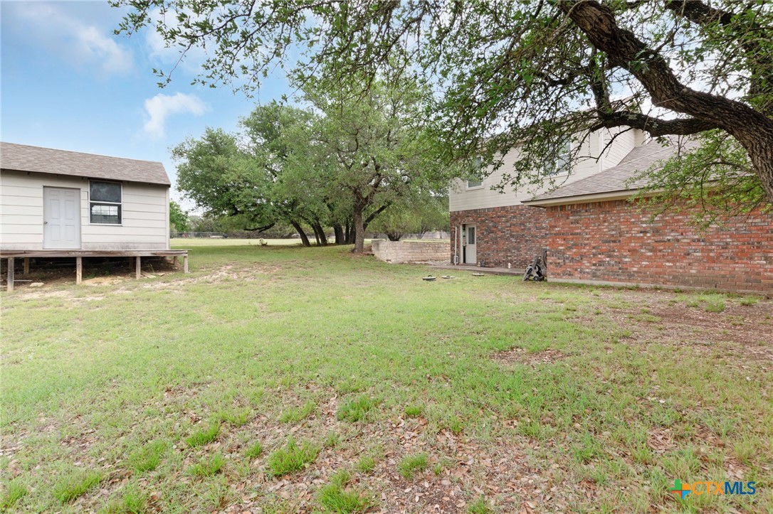 812 Taylor Creek Road Copperas Cove, TX 76522 - Photo 40 of 44 a backyard of a house with table and chairs