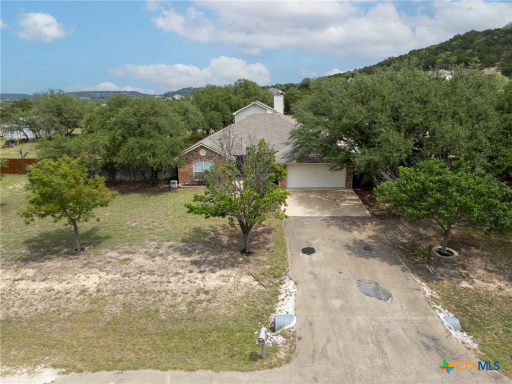 812 Taylor Creek Road Copperas Cove, TX 76522 - Photo 42 of 44 a view of a yard with plants and a bench