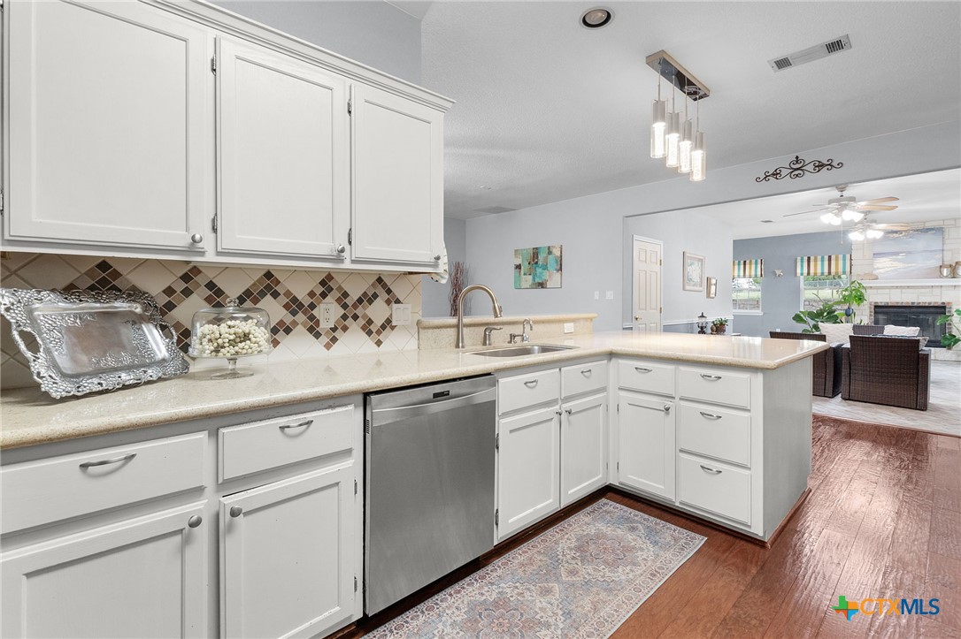 812 Taylor Creek Road Copperas Cove, TX 76522 - Photo 5 of 44 a kitchen with granite countertop white cabinets and white appliances