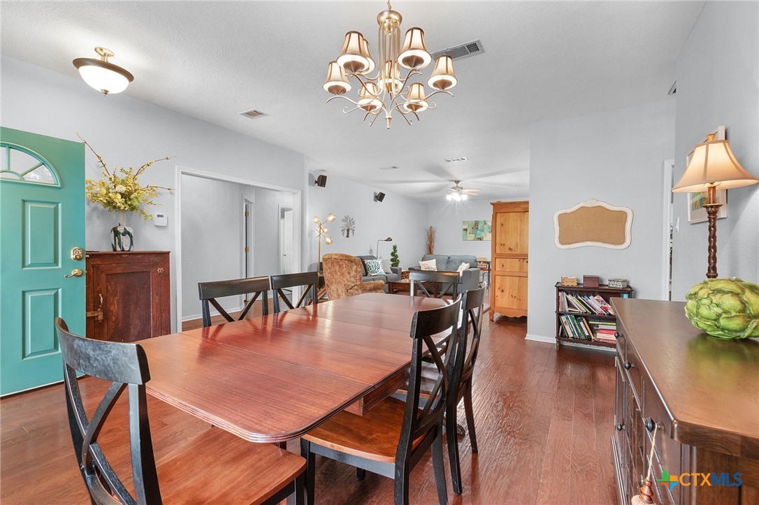812 Taylor Creek Road Copperas Cove, TX 76522 - Photo 10 of 44 a dining room filled chandelier and wooden floor