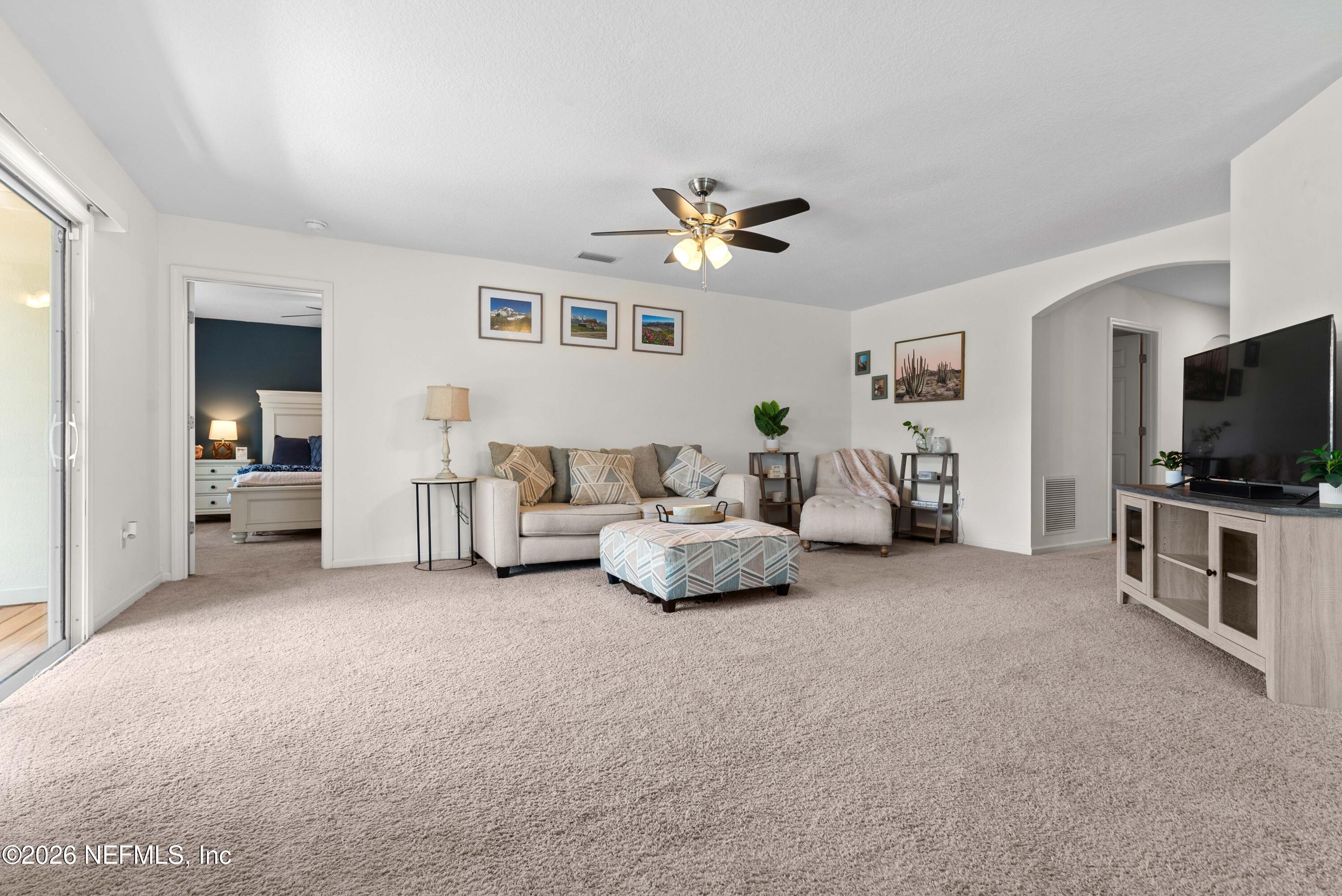 6178 Daylilly Road Macclenny, FL 32063 - Photo 7 of 29 a living room with furniture and a flat screen tv