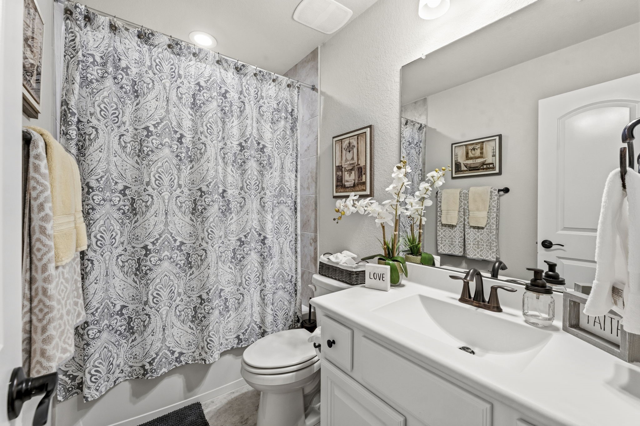 14012 Beartooth Bend Trail Conroe, TX 77384 - Photo 33 of 50 The full bathroom for Bedroom 4 and any second floor guests includes tile flooring, single sink with quartz countertop and integrated sink, commode, and tiled shower/tub with built-in toiletry niches.