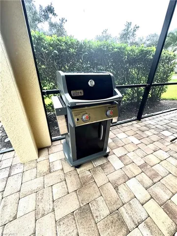 a living room with patio furniture and a large window