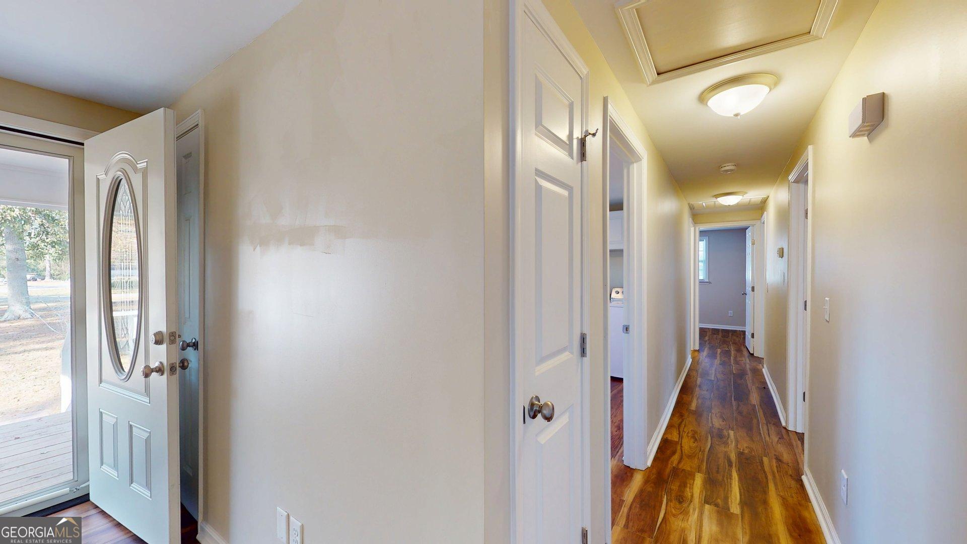 142 Bill Brown Road Pembroke, GA 31321 - Photo 13 of 33 a view of a hallway with a door and wooden floor